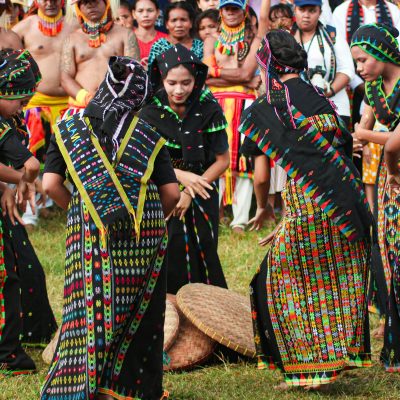 Home Women in colorful traditional attire perform a lively dance in Badjo, Indonesia.