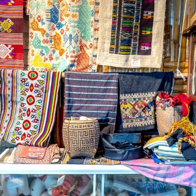 A vibrant collection of traditional textiles with intricate patterns and bold colors.